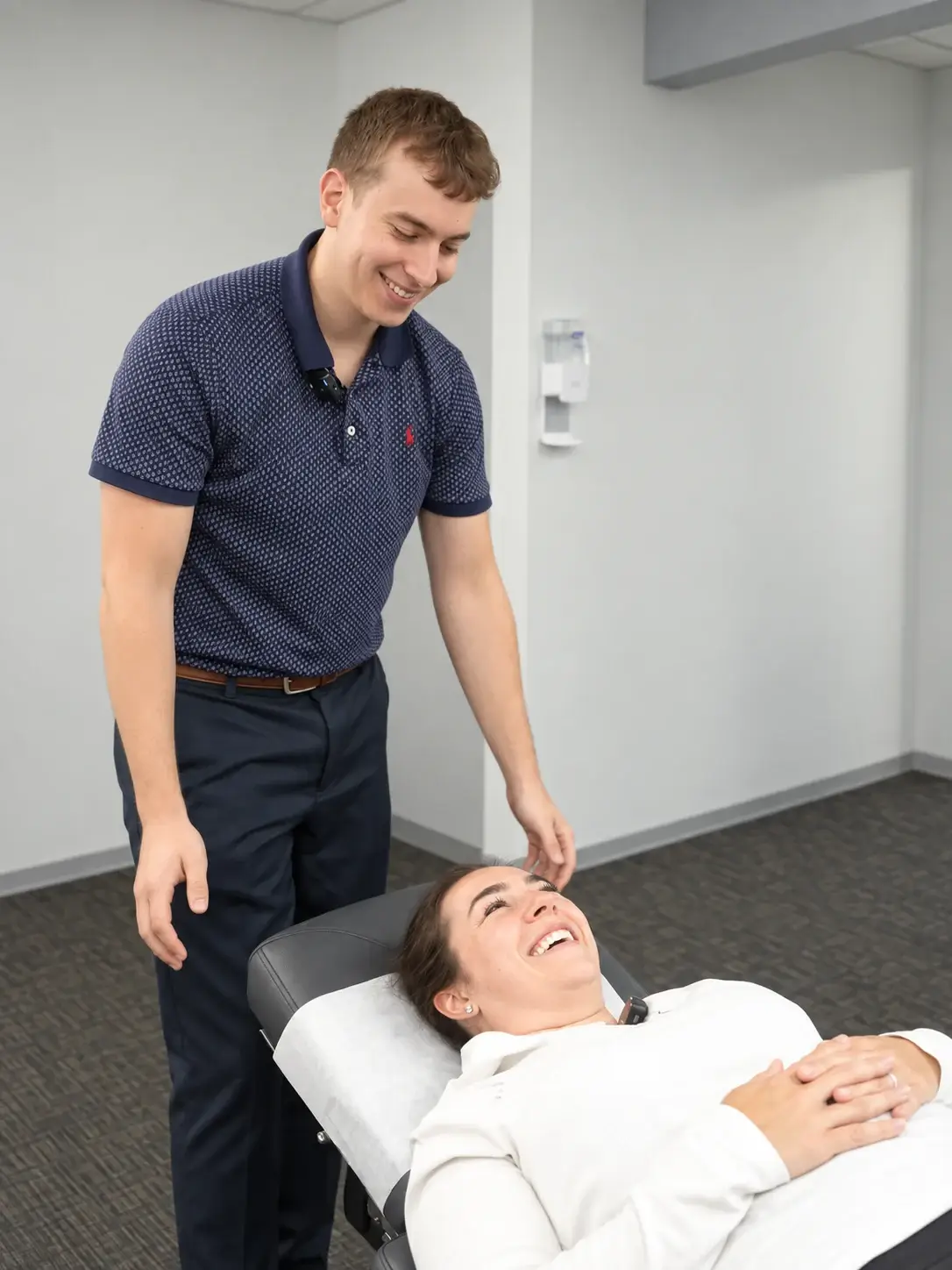Dr. Brian Donovan talking with a patient after her injury treatment