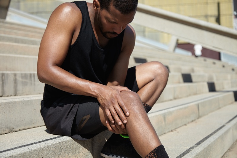 Patient suffering from arm and leg pain, treated at Nuro Chiropractic in Brooklyn, NY