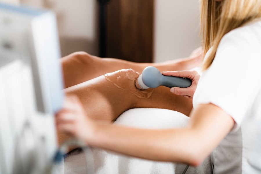 SoftWave therapy applied to a patient's knee at Nuro Chiropractic in Brooklyn, NY