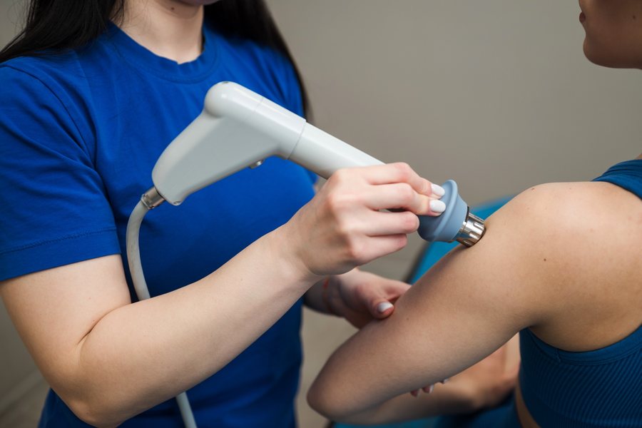 Shockwave therapy applied to a patient's elbow at Nuro Chiropractic in Brooklyn, NY