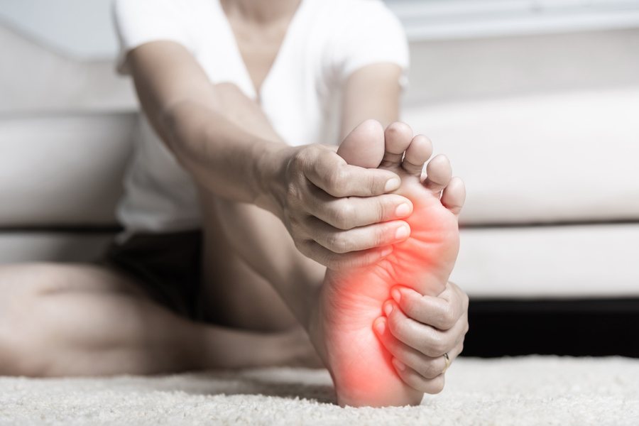 Woman with plantar fasciitis heel pain, evaluated by Dr. Brian Donovan at Nuro Chiropractic in Brooklyn