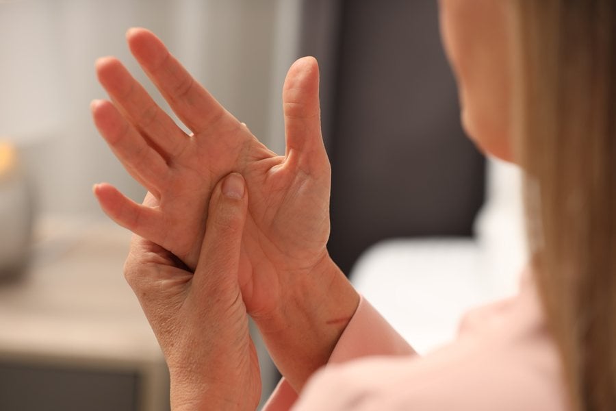 Woman with numbness and tingling in her hand, evaluated by Dr. Brian Donovan at Nuro Chiropractic in Brooklyn