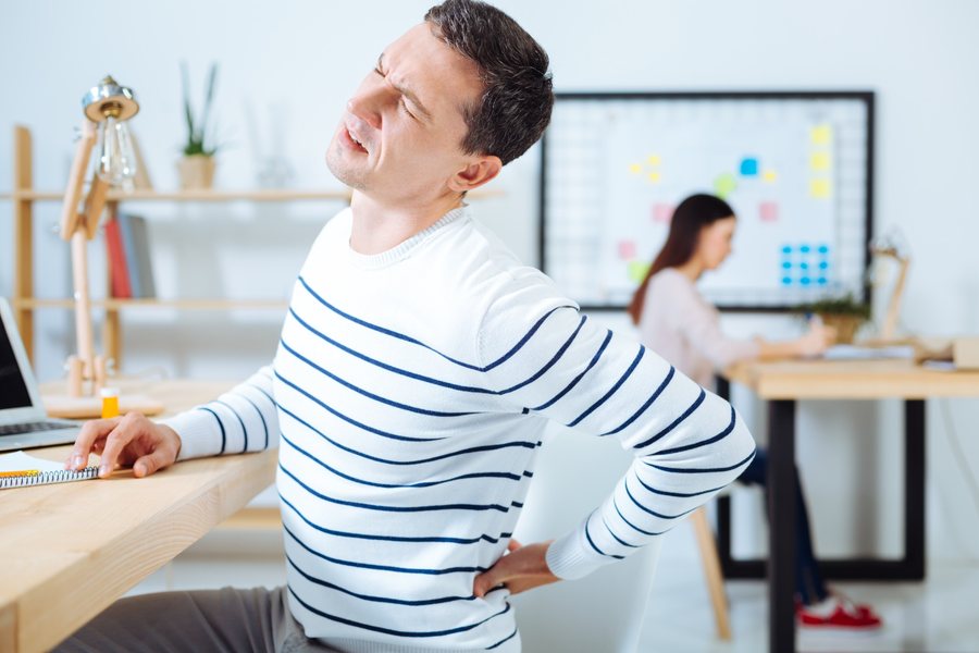 Man with herniated disc pain in his back, evaluated by Dr. Brian Donovan at Nuro Chiropractic in Brooklyn